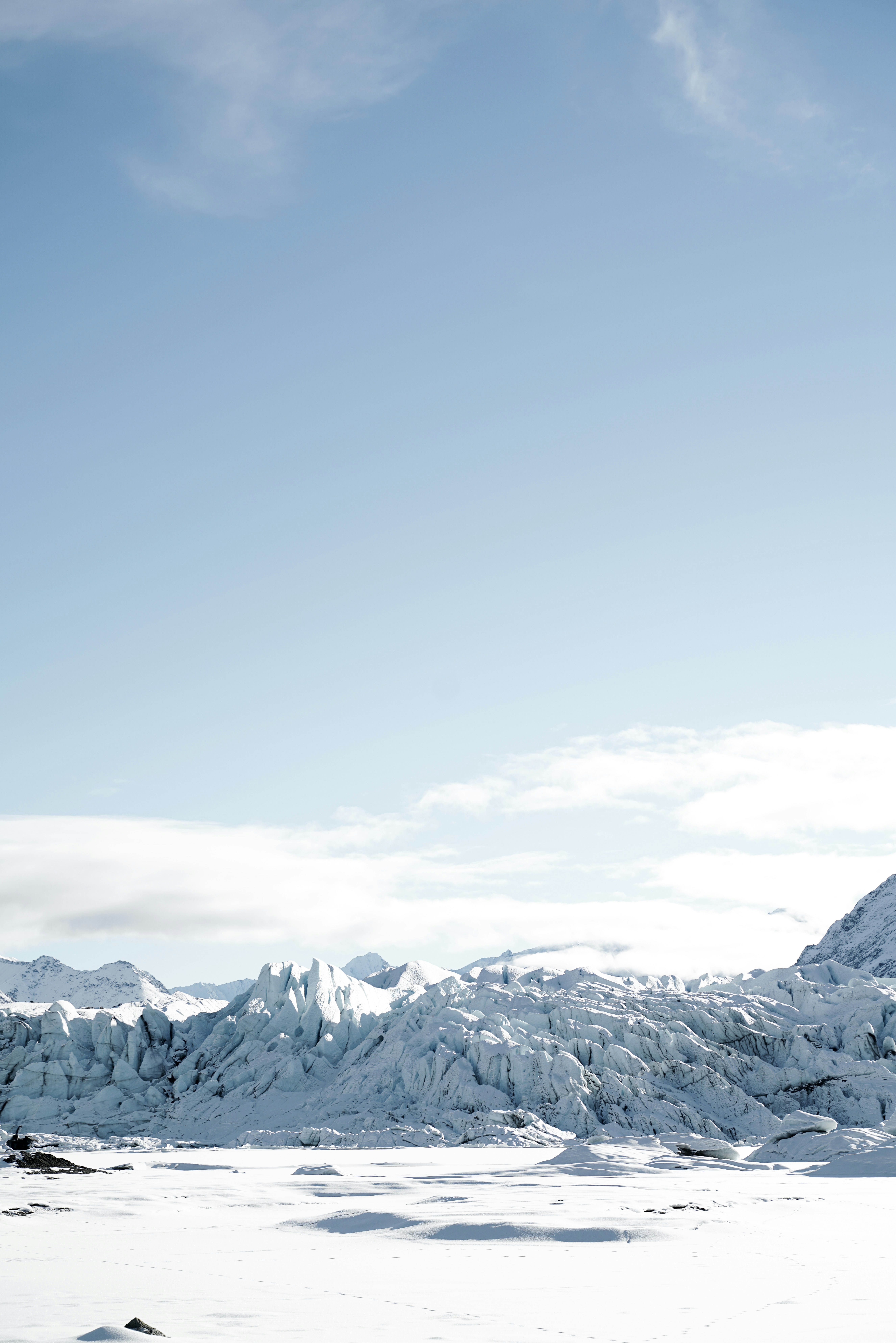 a snowy landscape with a mountain in the background