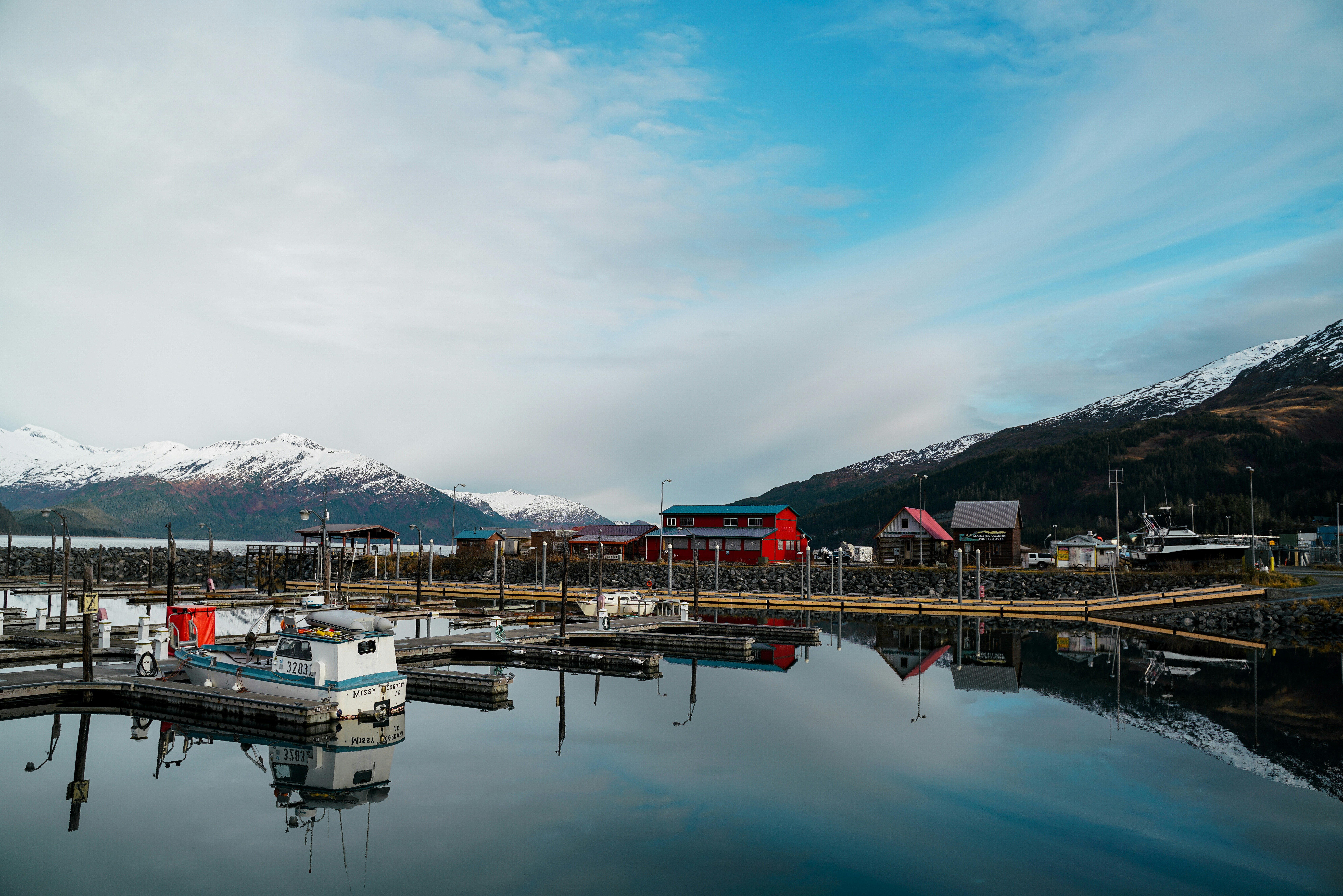 a boat is docked at a dock in the water, 