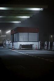 a gas station at night with lights on
