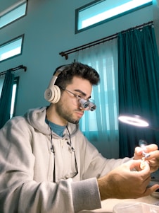 a man sitting at a table with headphones on