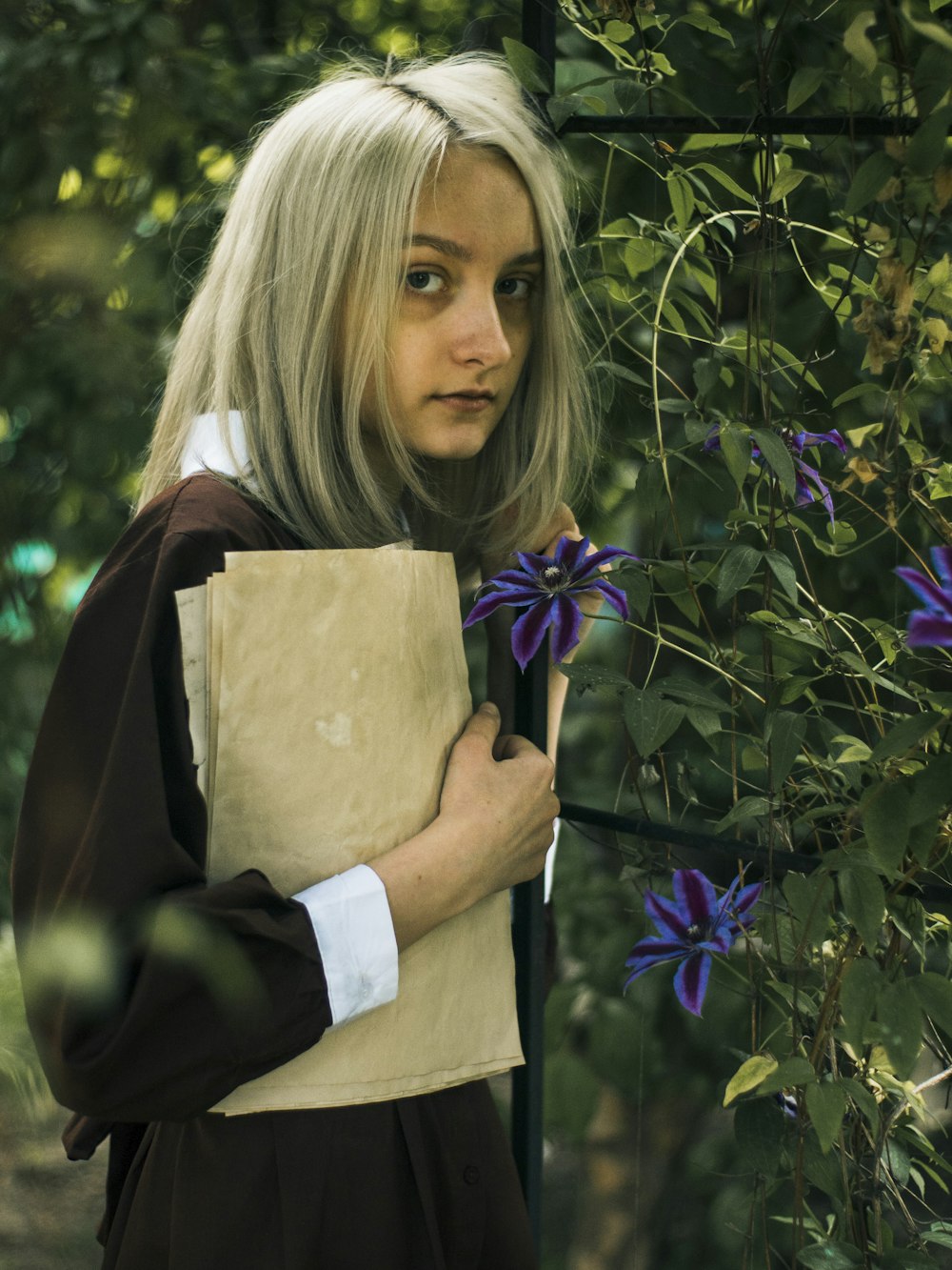 a woman with blonde hair holding a brown paper bag