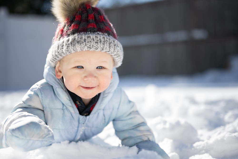 a small child is playing in the snow