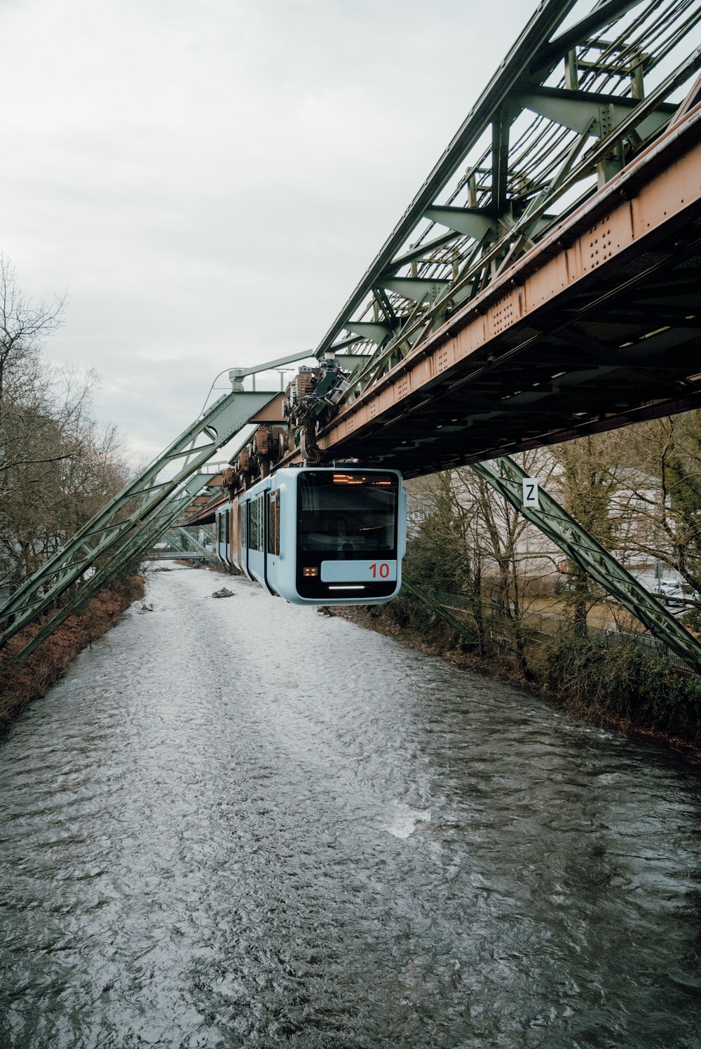 a train traveling over a bridge over a river