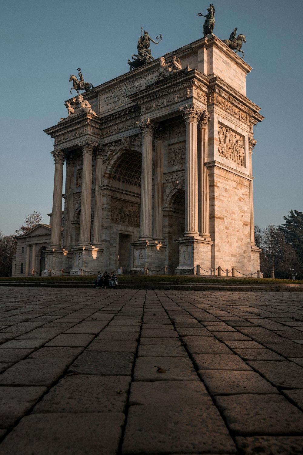 a stone arch with statues on top of it