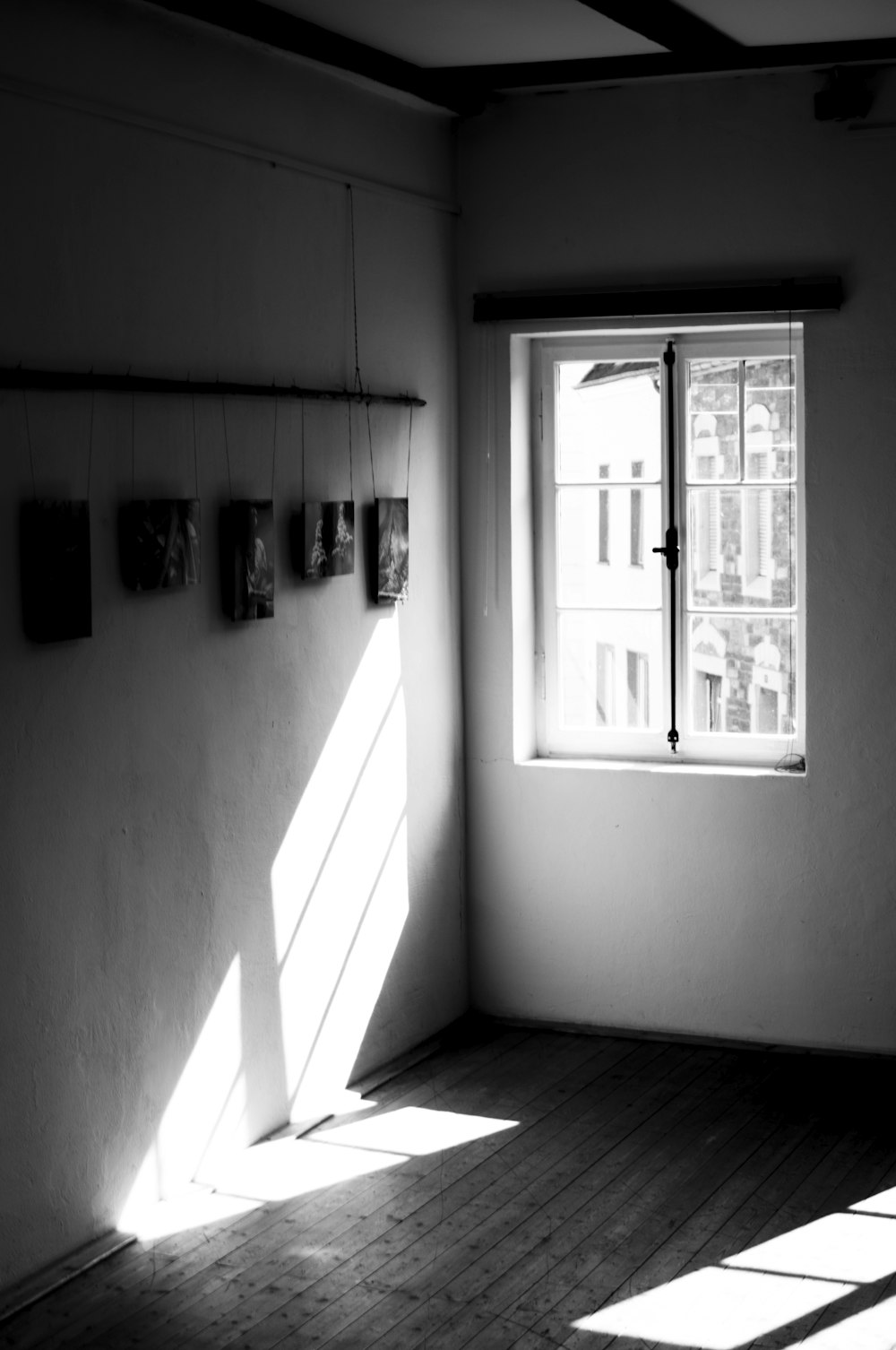 a black and white photo of a sunlit room