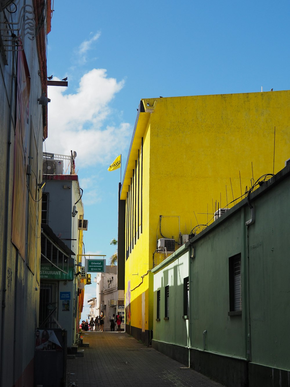 a yellow building on the side of a street