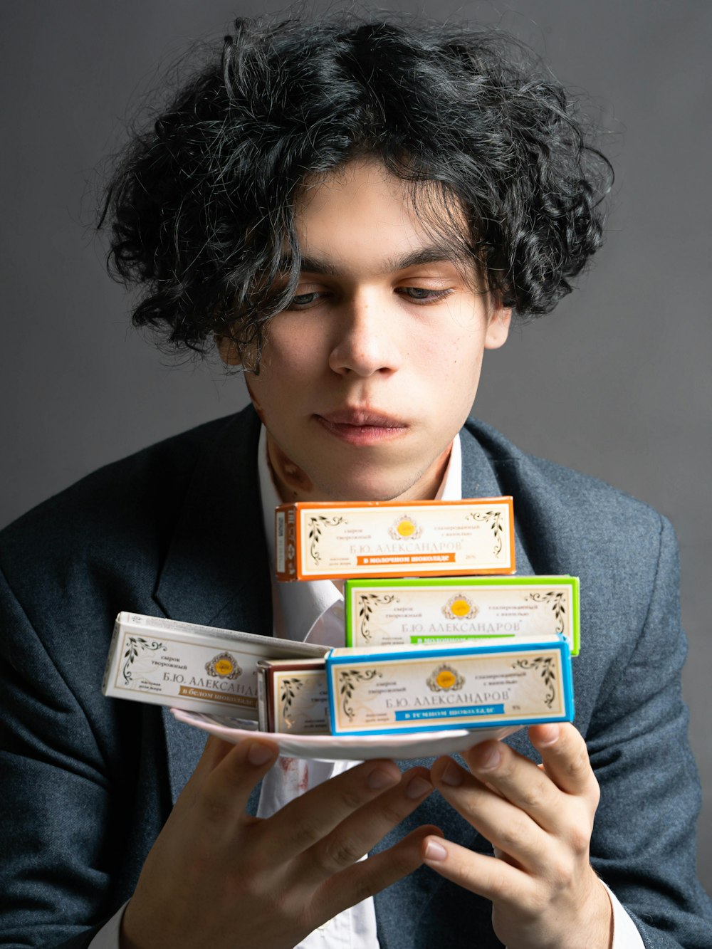 a man in a suit holding a stack of business cards