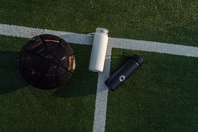 a soccer ball and a water bottle on a soccer field