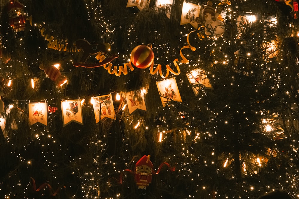 a christmas tree with lights and pictures on it