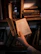 Portrait of a thoughtful man holding an open book in a cozy library corner.