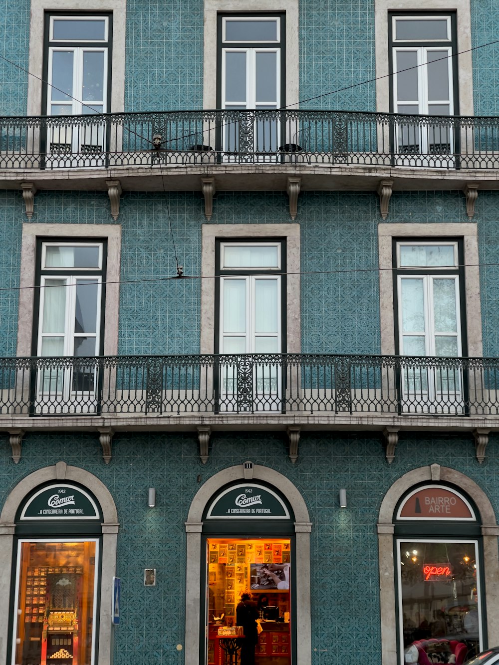 a blue building with a clock on the front of it