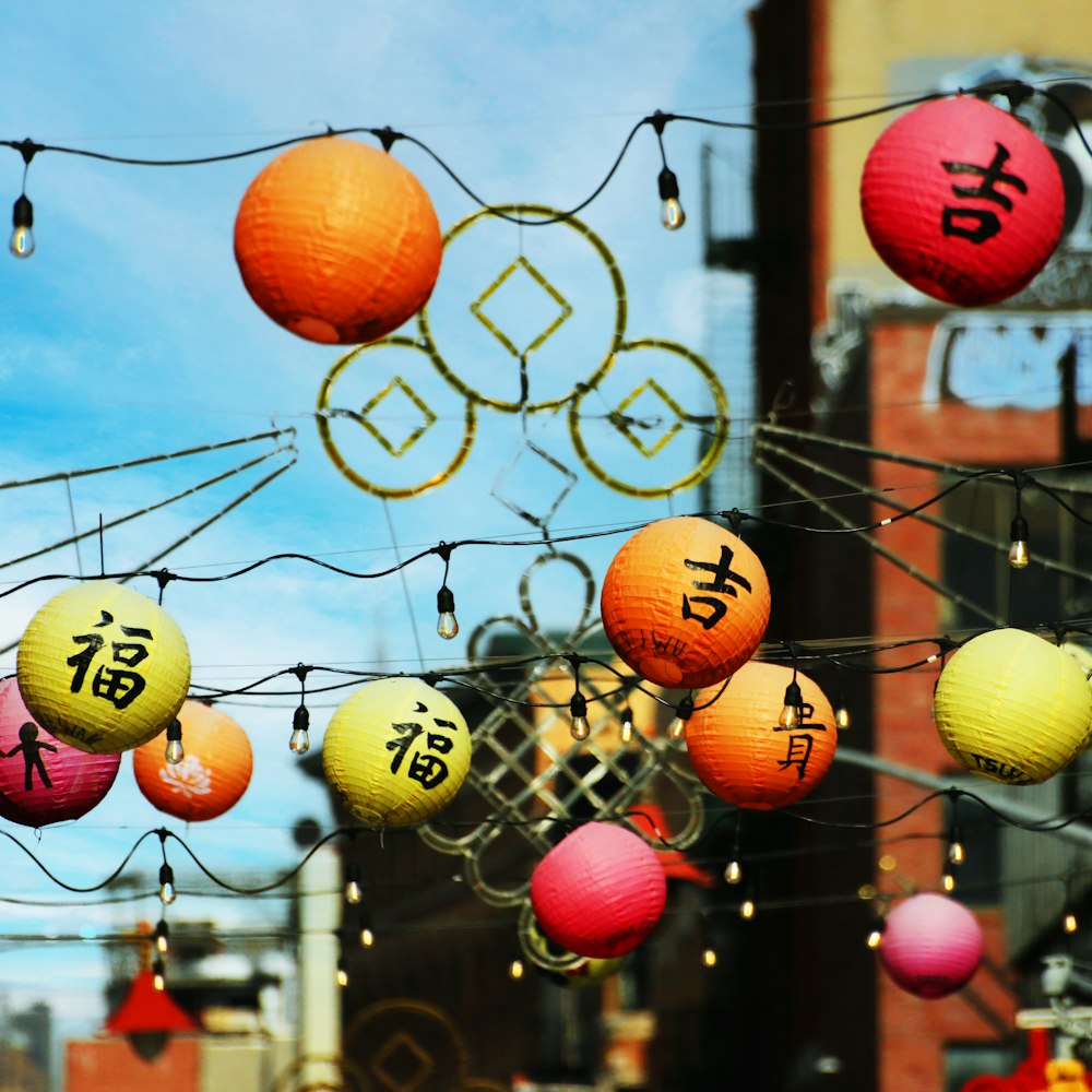 a bunch of chinese lanterns hanging from a wire