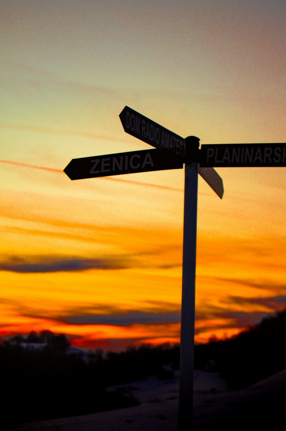 a couple of street signs sitting on top of a pole