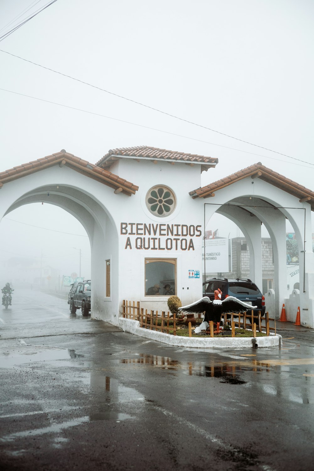 a white building with a car parked in front of it