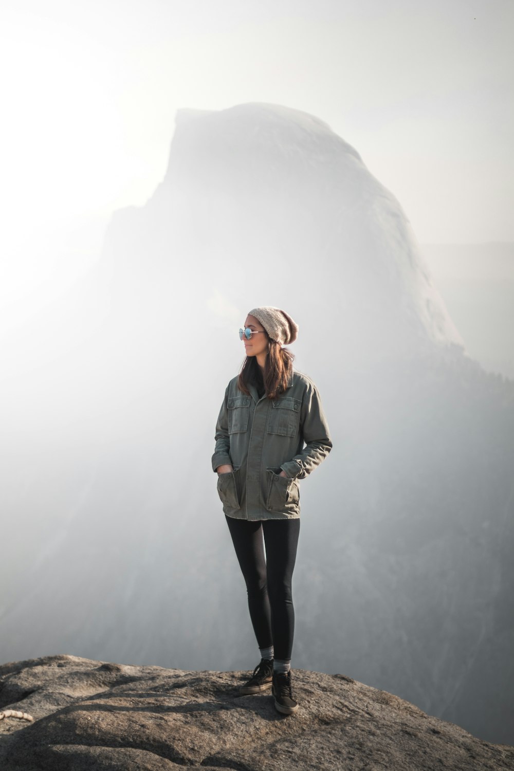 a woman standing on top of a mountain