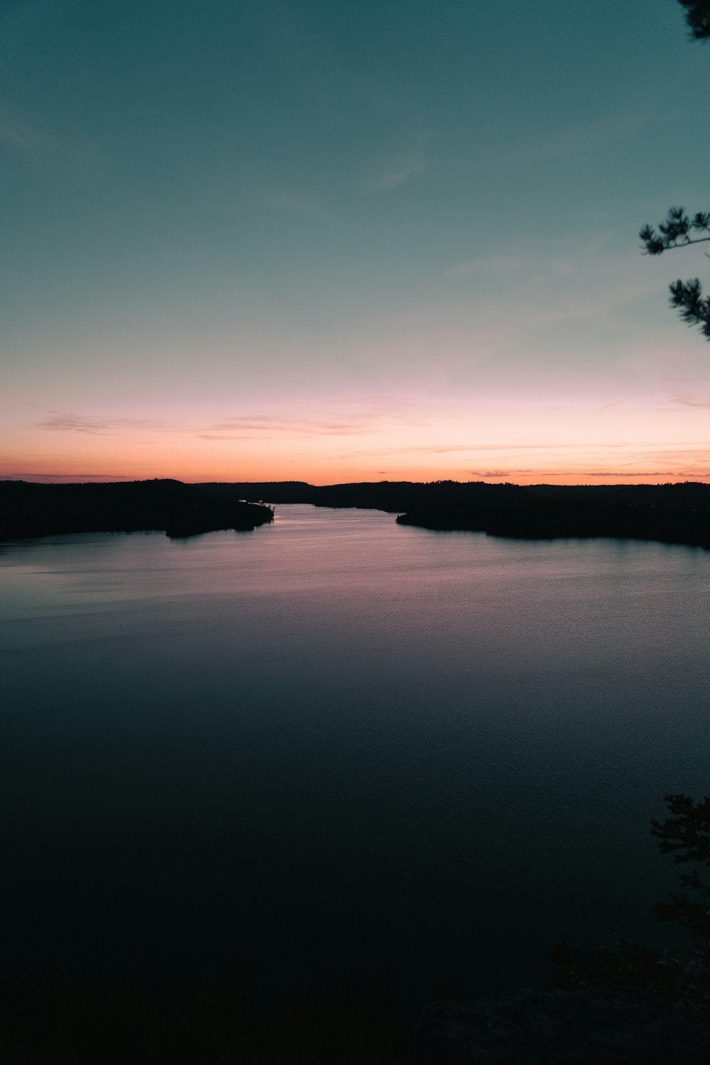 the sun is setting over a body of water