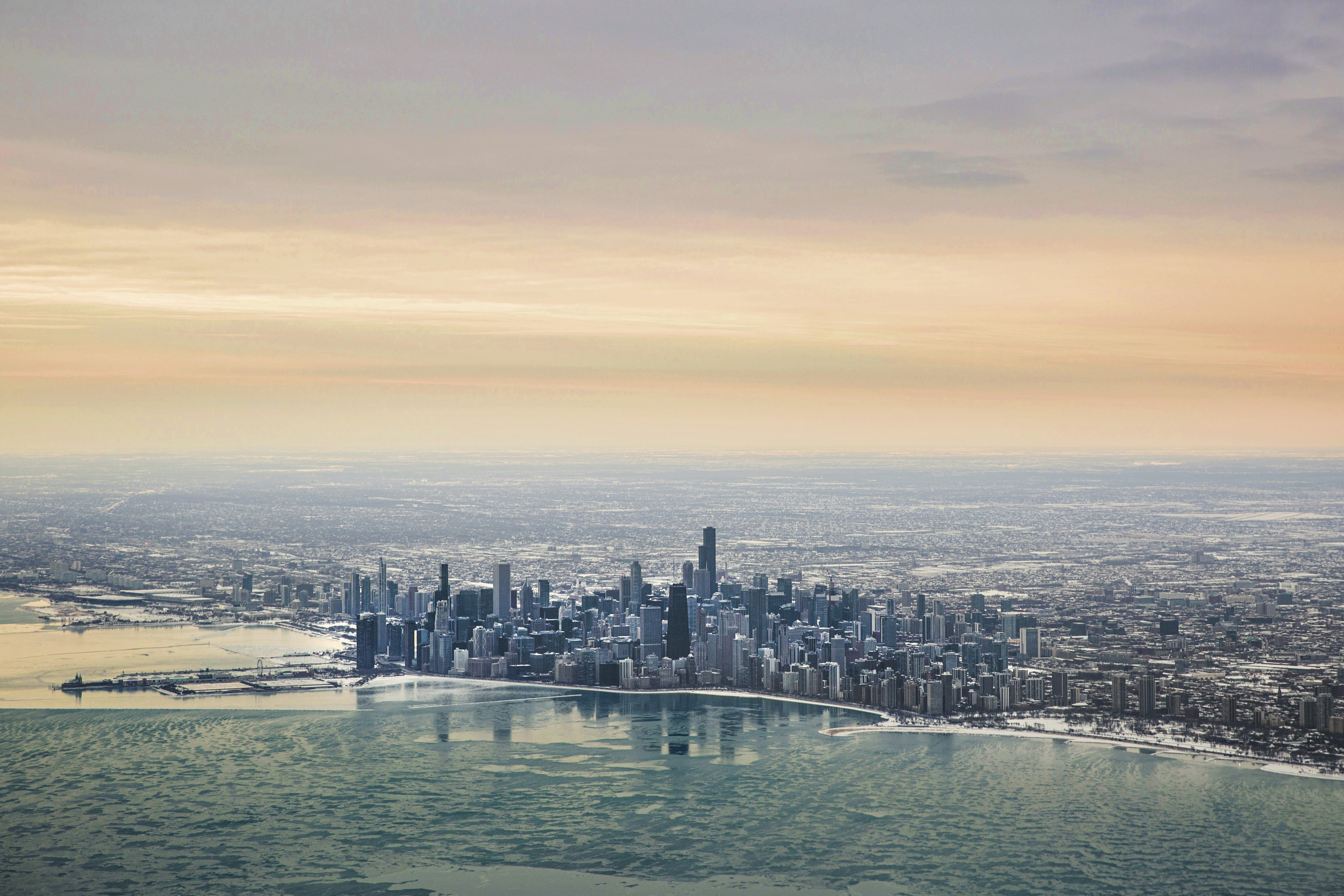 an aerial view of a city and a body of water