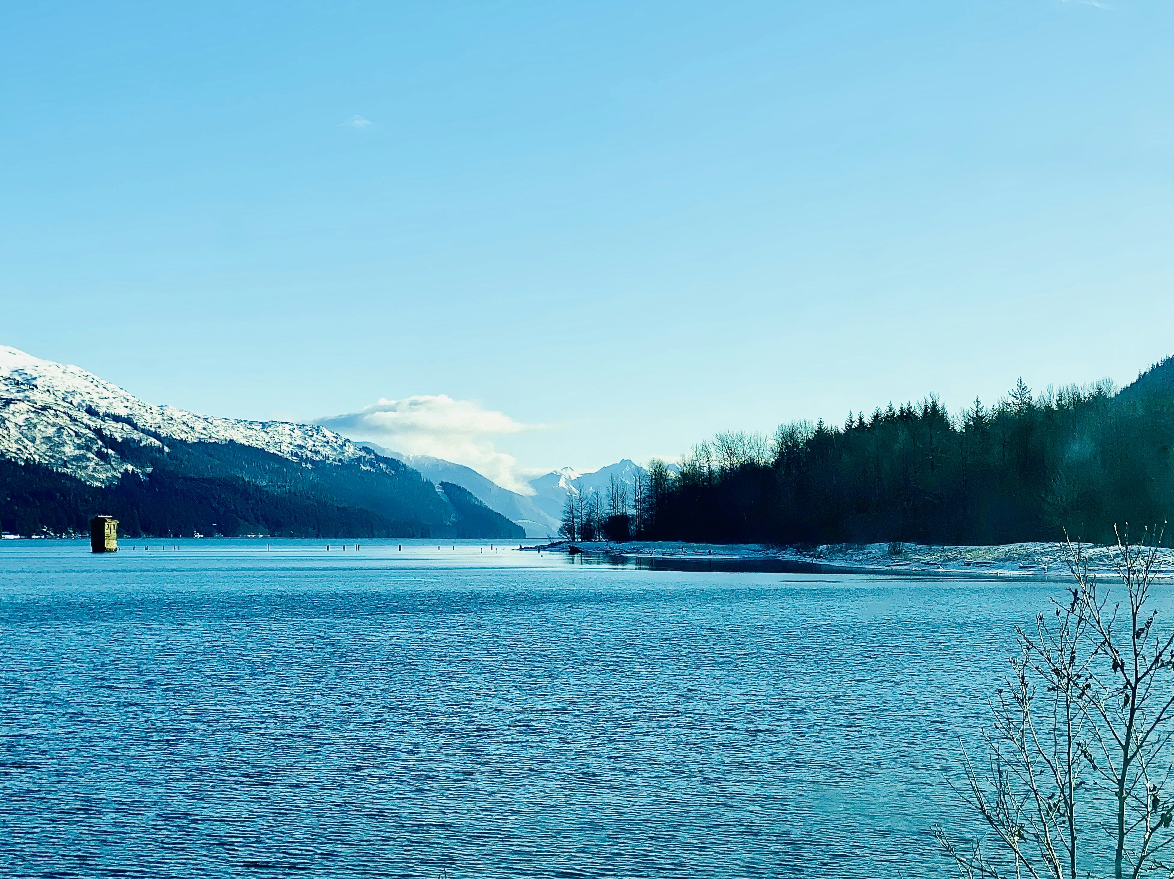 a large body of water surrounded by mountains, Douglas, Alaska Sandy Beach 2022