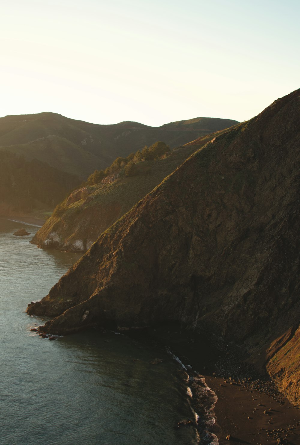 a body of water near a mountain side