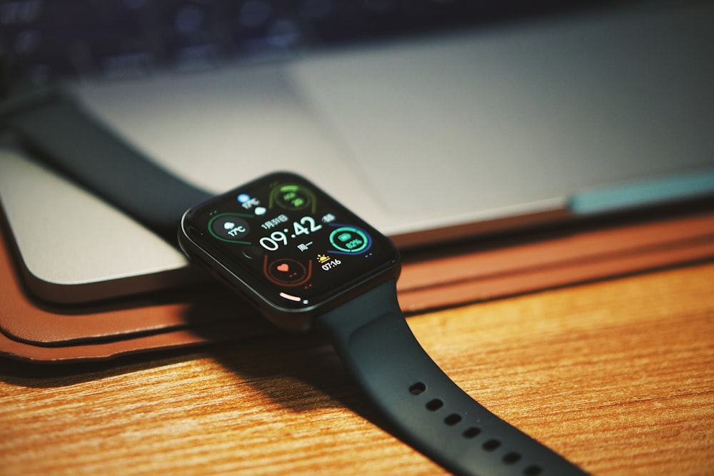 a smart watch sitting on top of a wooden table