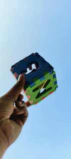 A candid shot of a smiling customer using cube products outdoors on a sunny day.