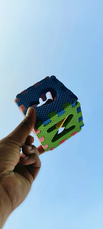 A candid shot of a smiling customer using cube products outdoors on a sunny day.