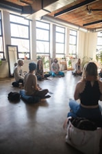 a group of people sitting on the floor in a room