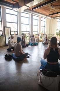 a group of people sitting on the floor in a room