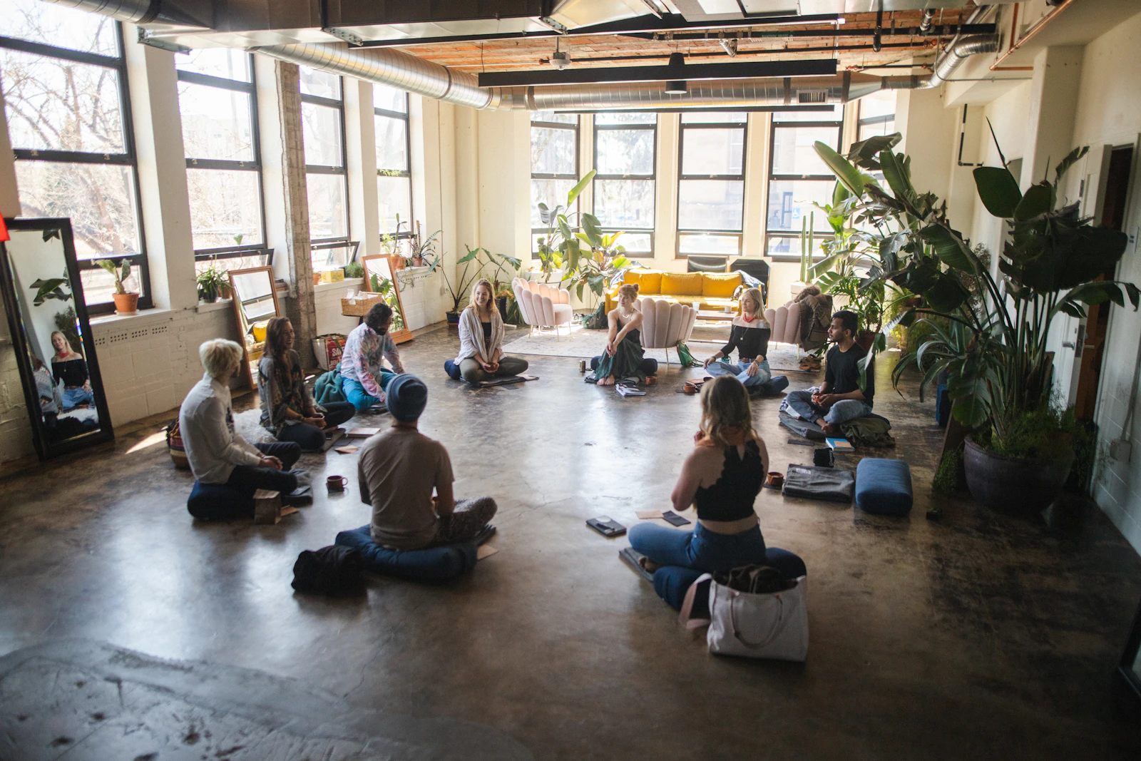 A group seated in a circle for a breathing and meditation session