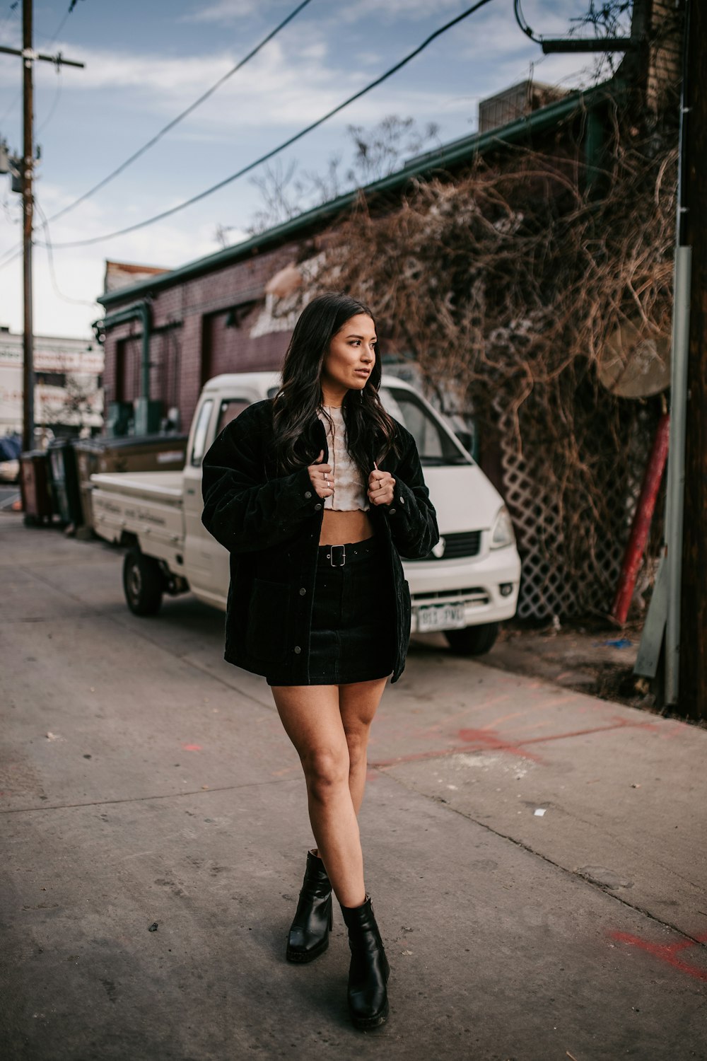 A woman walking down the street in a short skirt photo – Free Co Image on  Unsplash