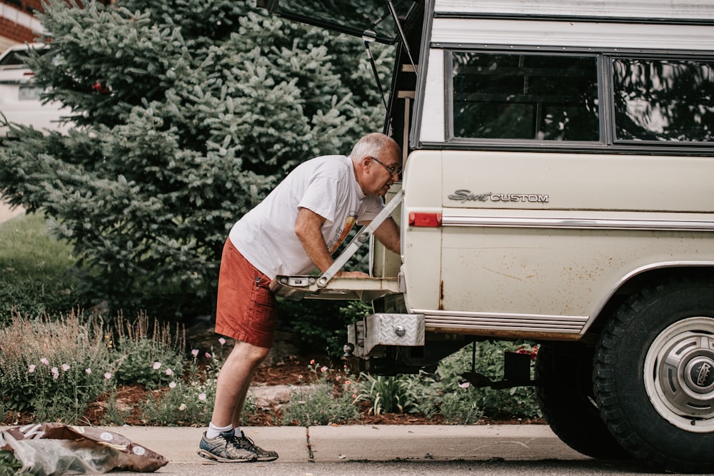 a man is loading something into the back of a van