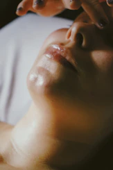 a woman getting a facial massage on her face