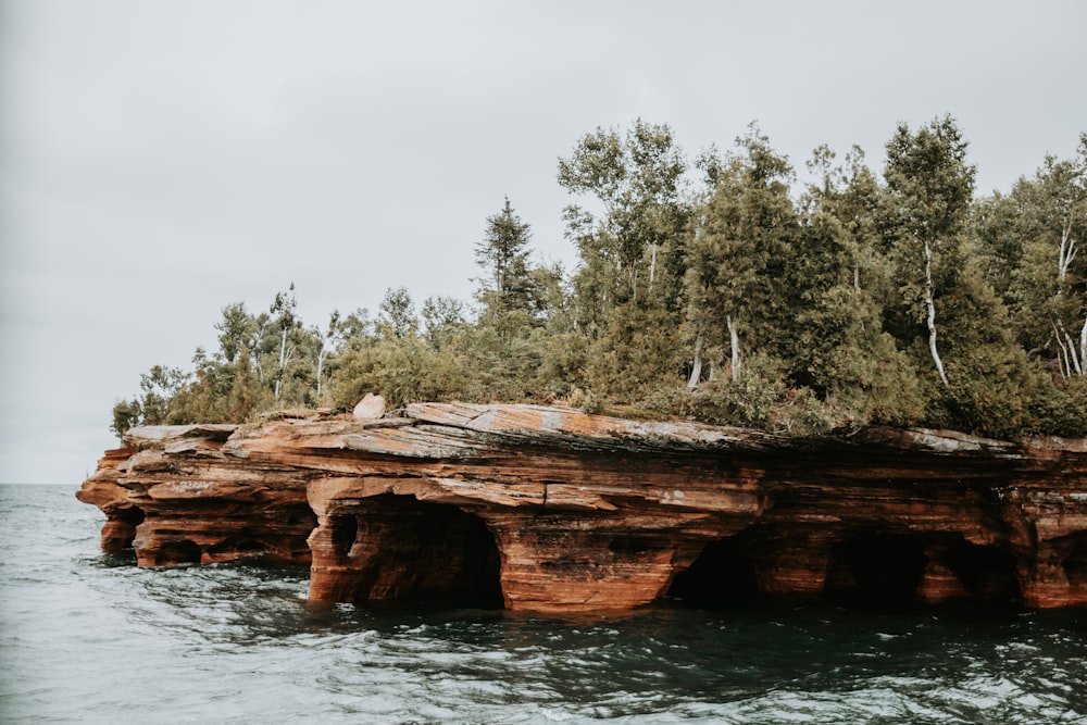 a rock formation in the middle of a body of water