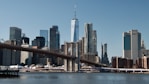 a view of a city skyline with a bridge in the foreground