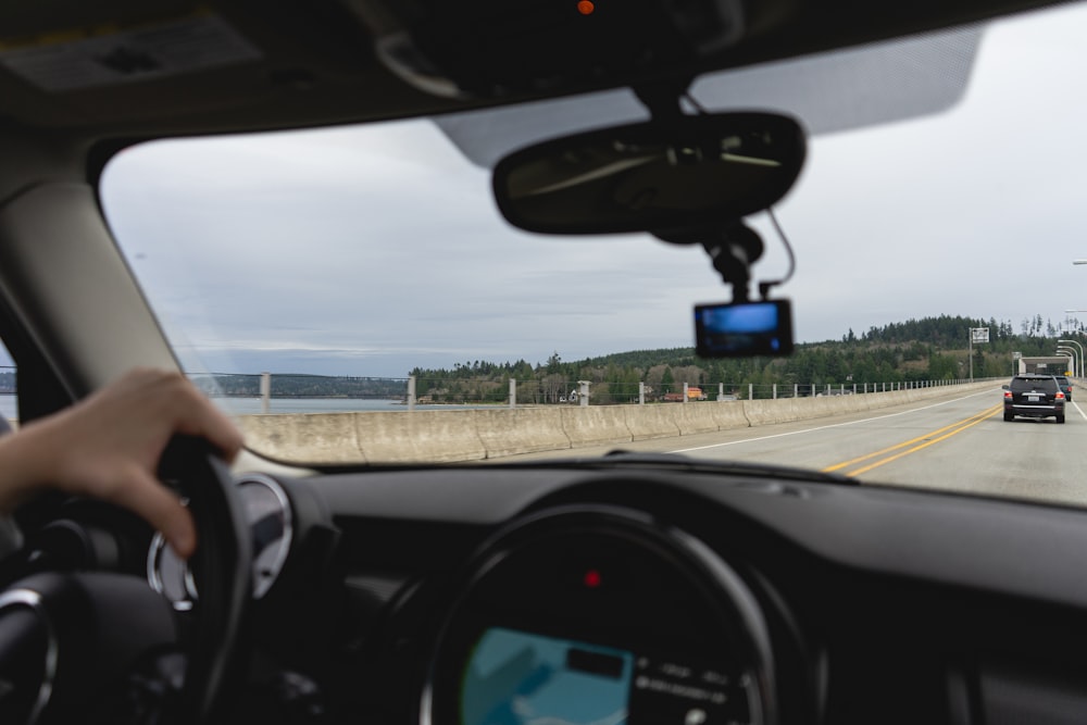 a person driving a car on a highway