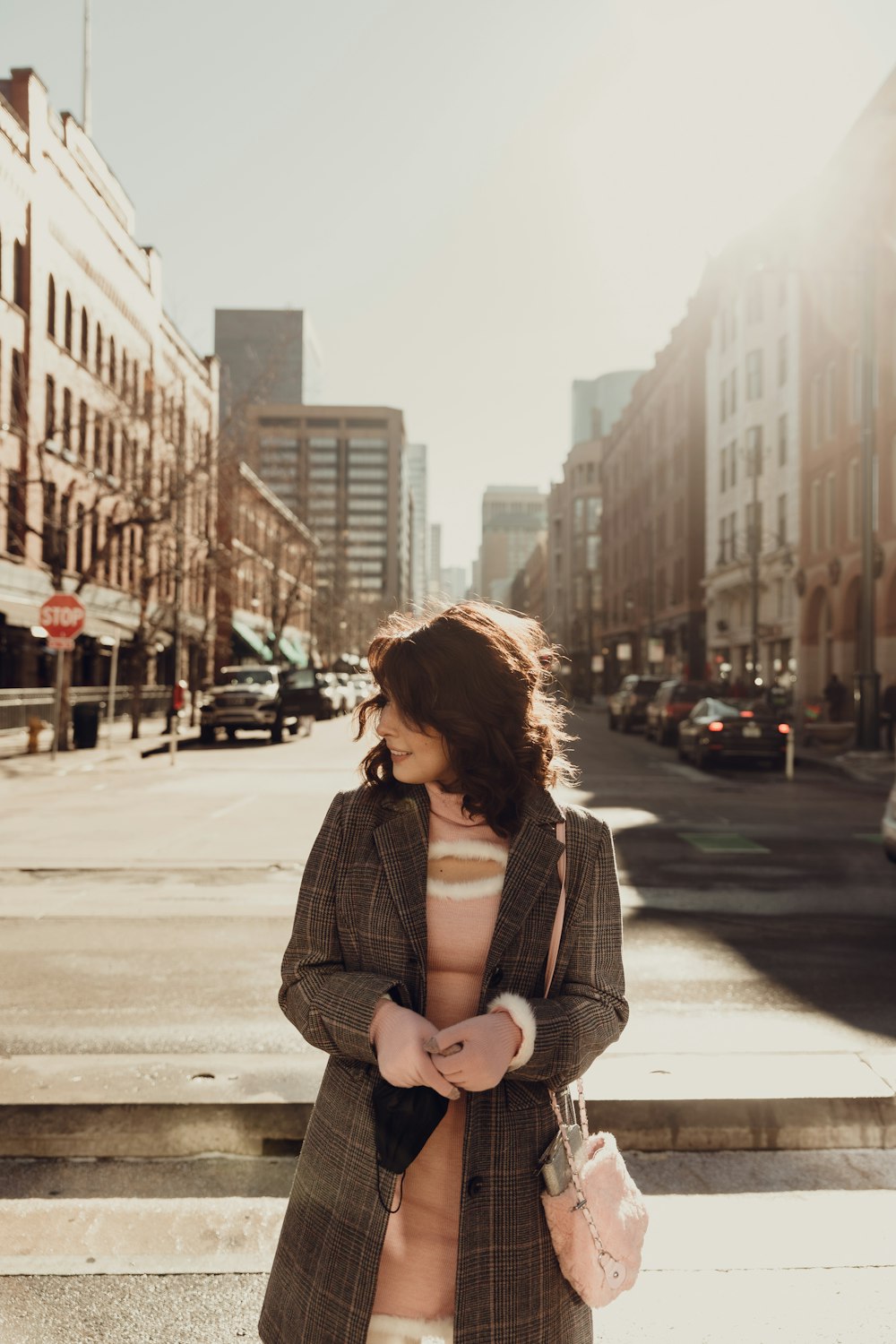 a woman is standing on the steps of a city street