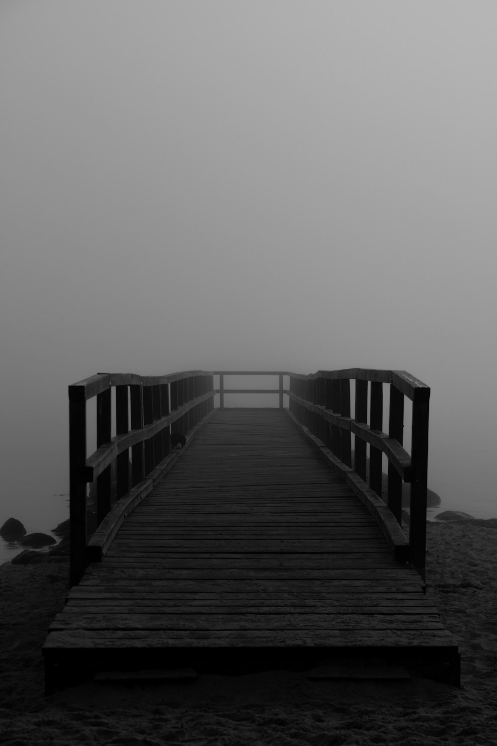 Una foto en blanco y negro de un puente de madera