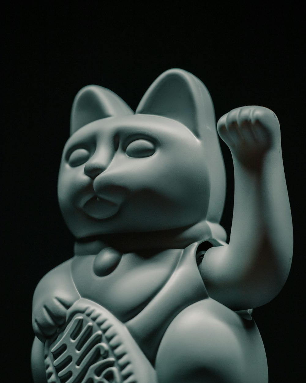 a statue of a cat holding a tennis racquet