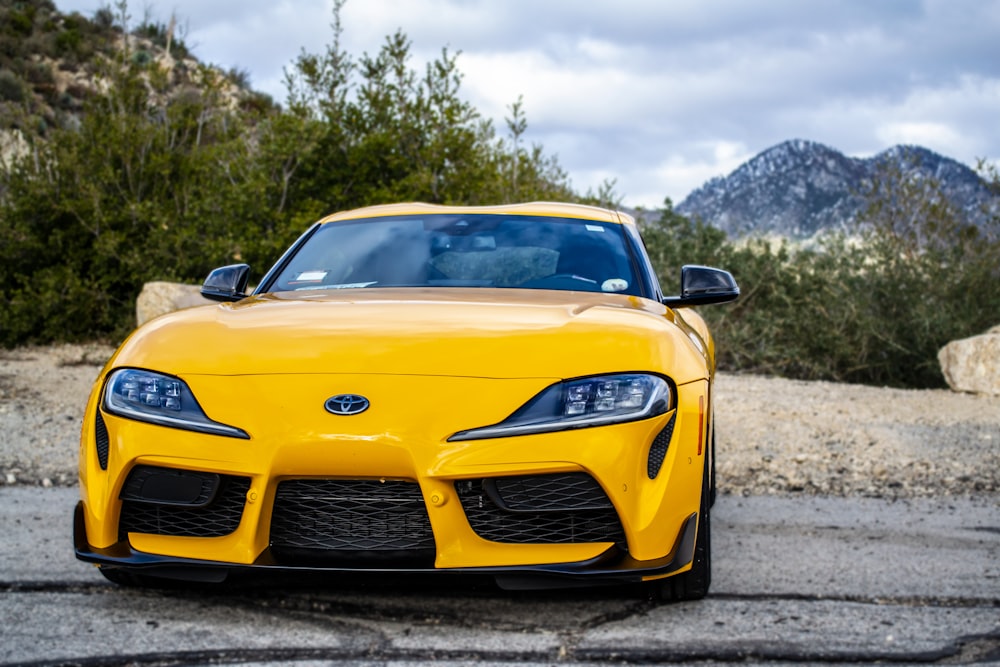 a yellow sports car parked in a parking lot