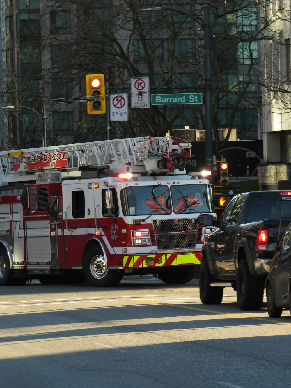 a fire truck and a police car on a city street