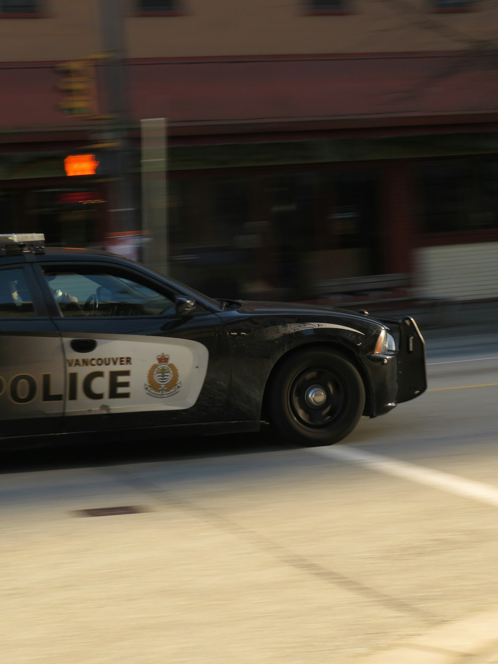 a police car driving down a city street