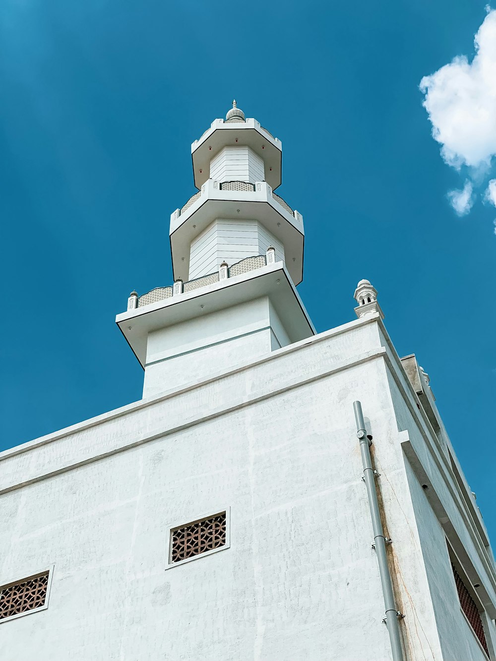 a tall white building with a clock on it's side