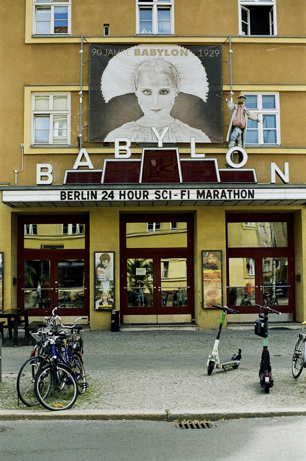 a person riding a bicycle in front of a building