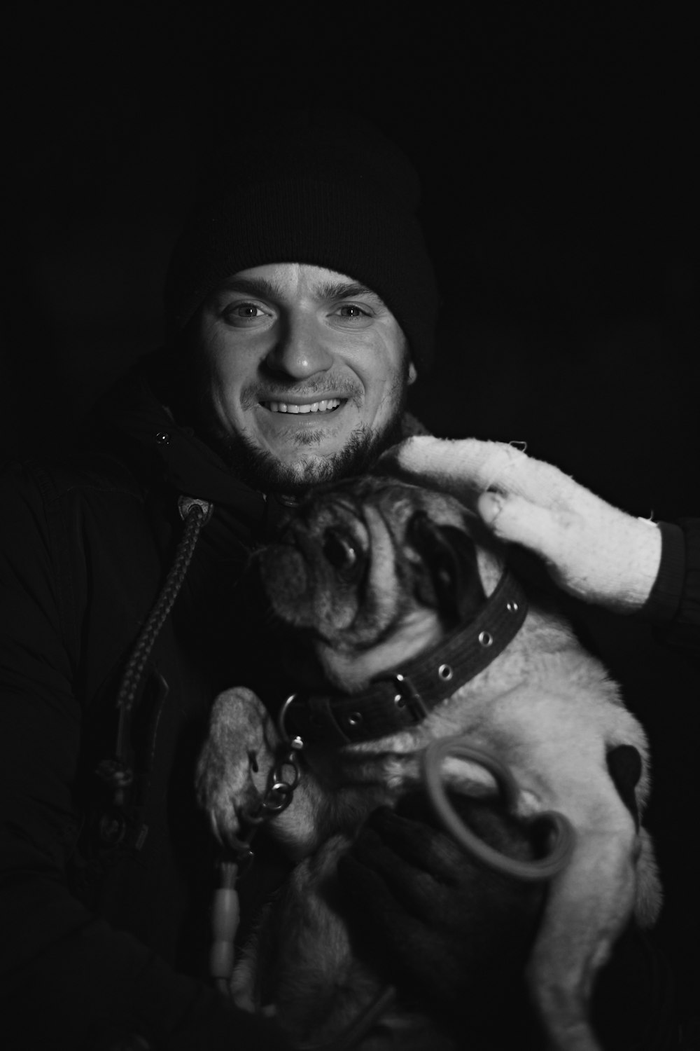 a man holding a dog in his arms