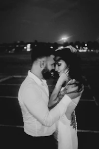 A sophisticated, elegant portrait of a black couple embracing, bathed in warm, cinematic lighting that highlights their connection.