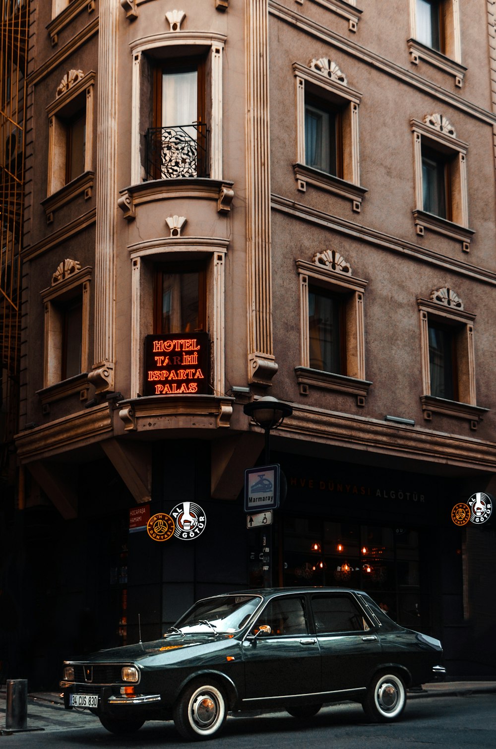 a car parked in front of a tall building