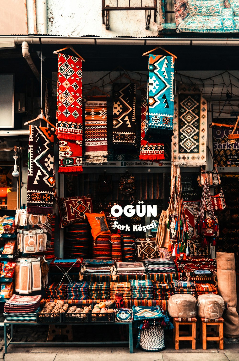 a store with a lot of colorful rugs and rugs on display