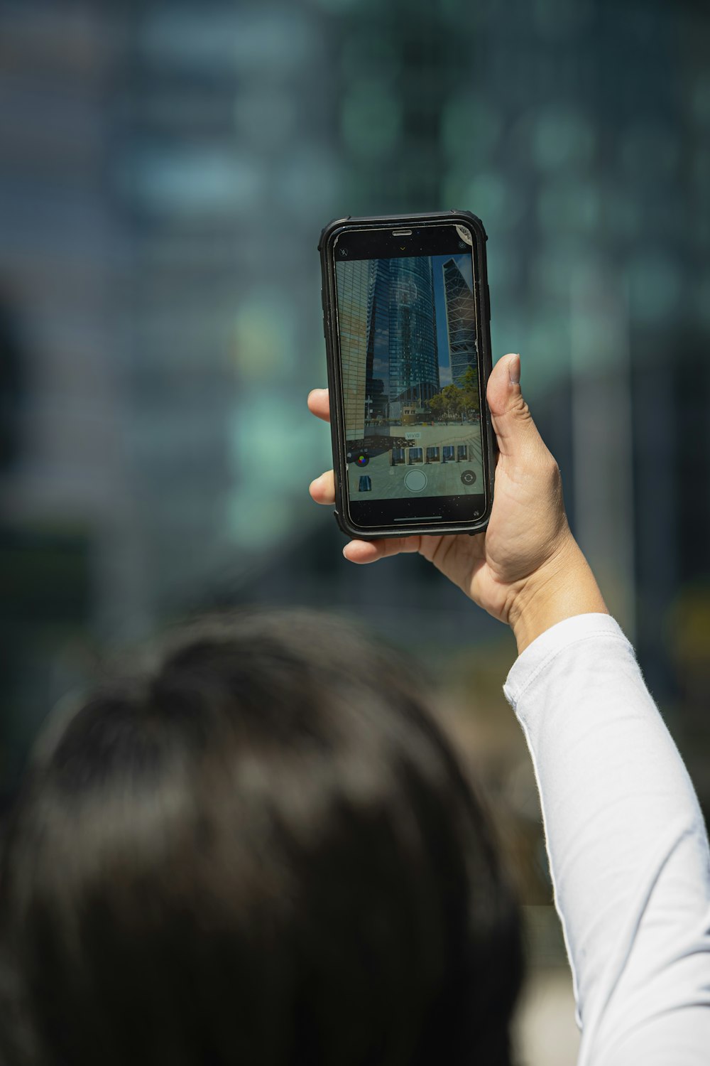 a person holding up a smart phone to take a picture