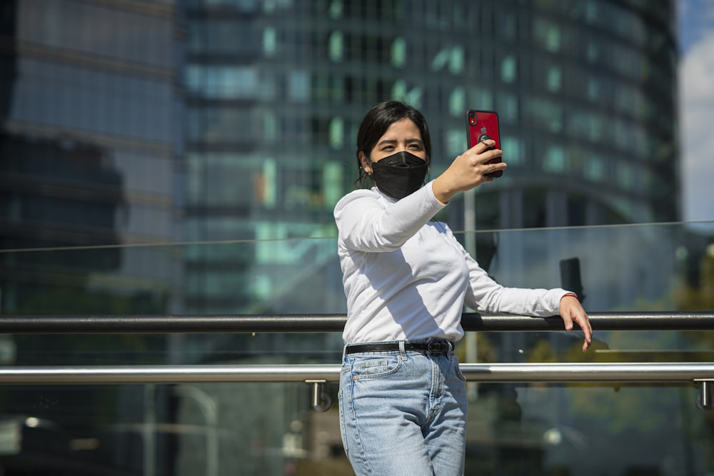 a man wearing a face mask taking a selfie