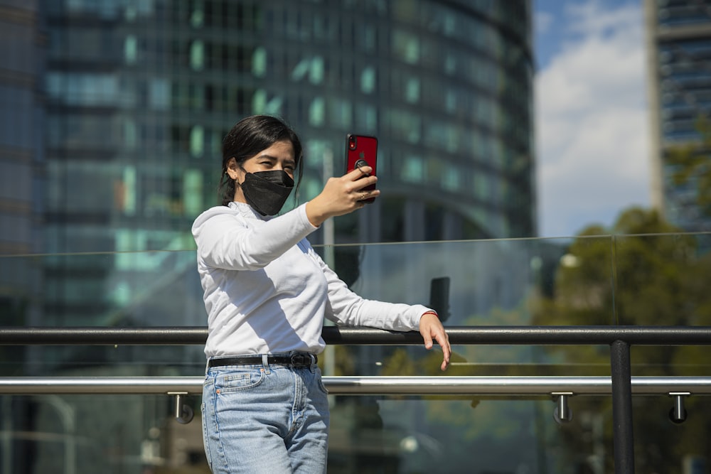 a woman wearing a face mask taking a selfie